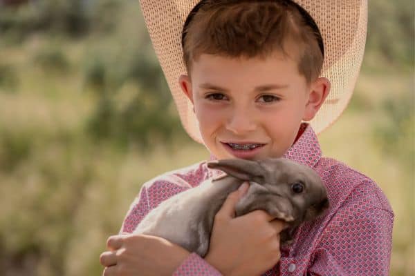 country boy holding a rabbit