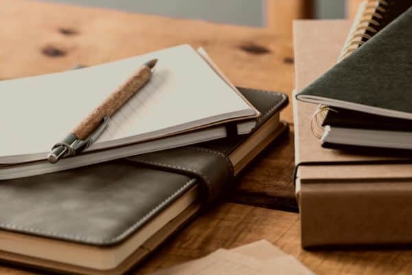 notebooks on a rustic table