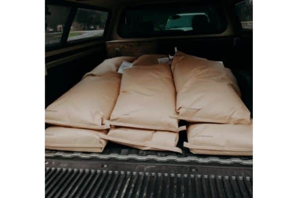 a truck bed full of rabbit feed bags
