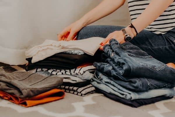 woman organizing and decluttering her closet for off-grid living