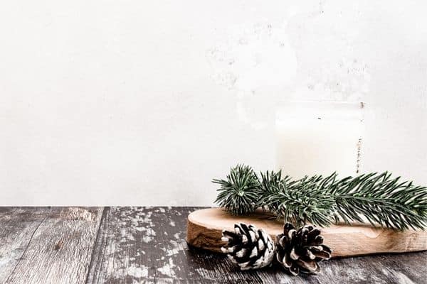 christmas candle, pine cones, and small pine branches